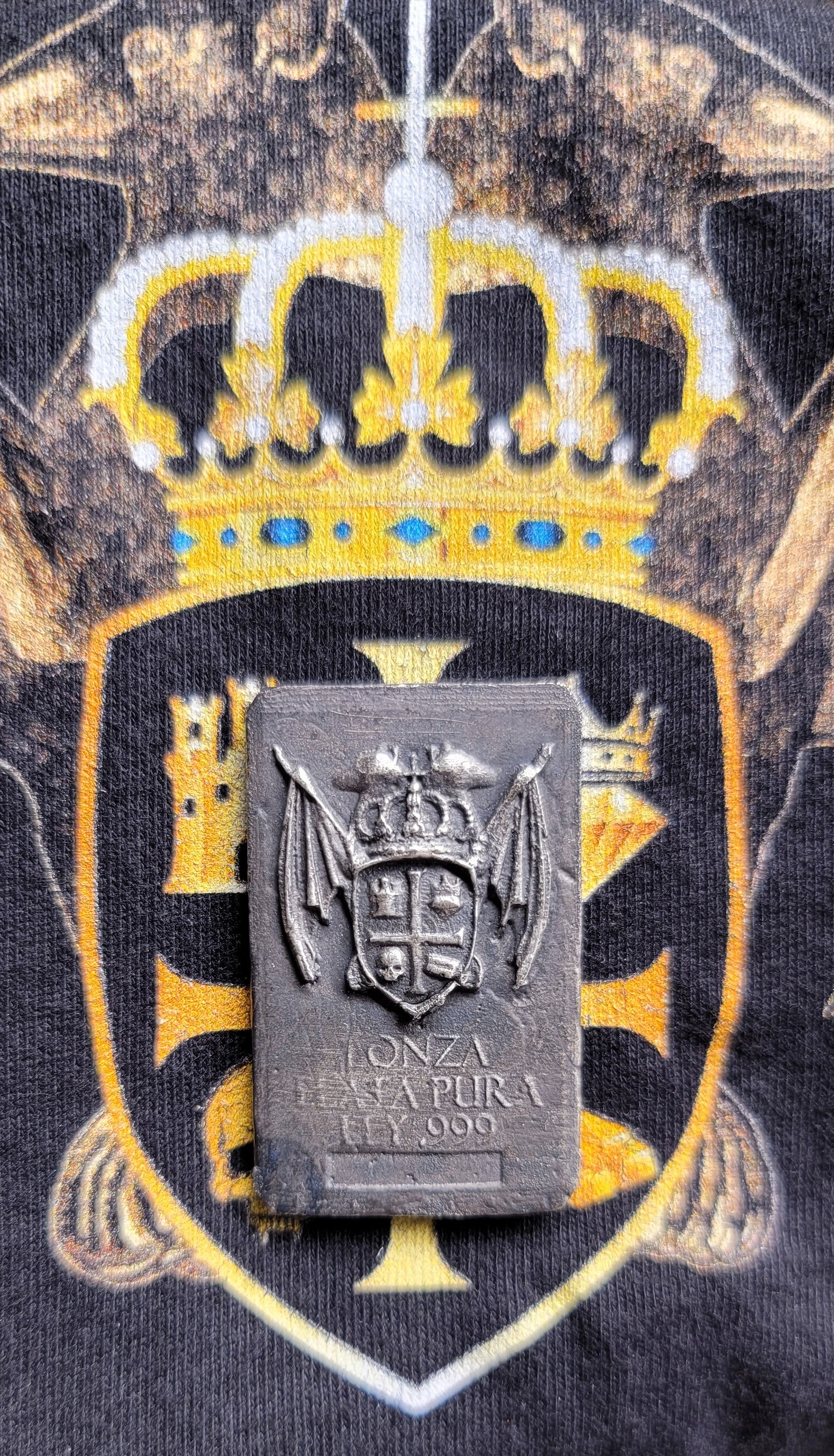 Coat of Arms Relic Bar in 1 oz .999 fine silver displayed over Kannibal Hektor coat of arms artwork