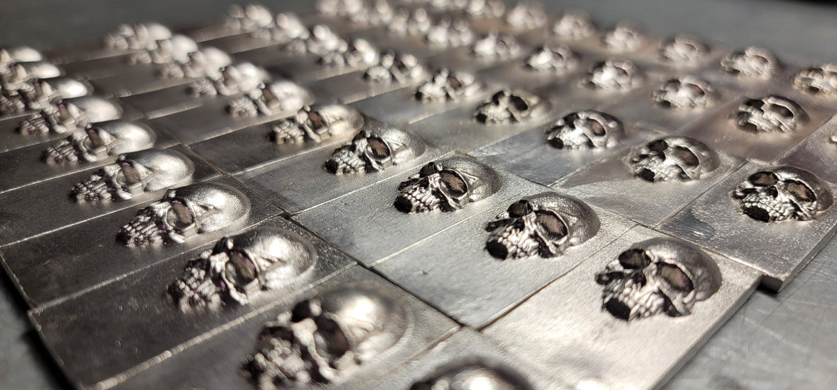 Group of 2025 Kannibal Skull Bars in .999 fine silver, showing repeated raised skull relief across the limited run