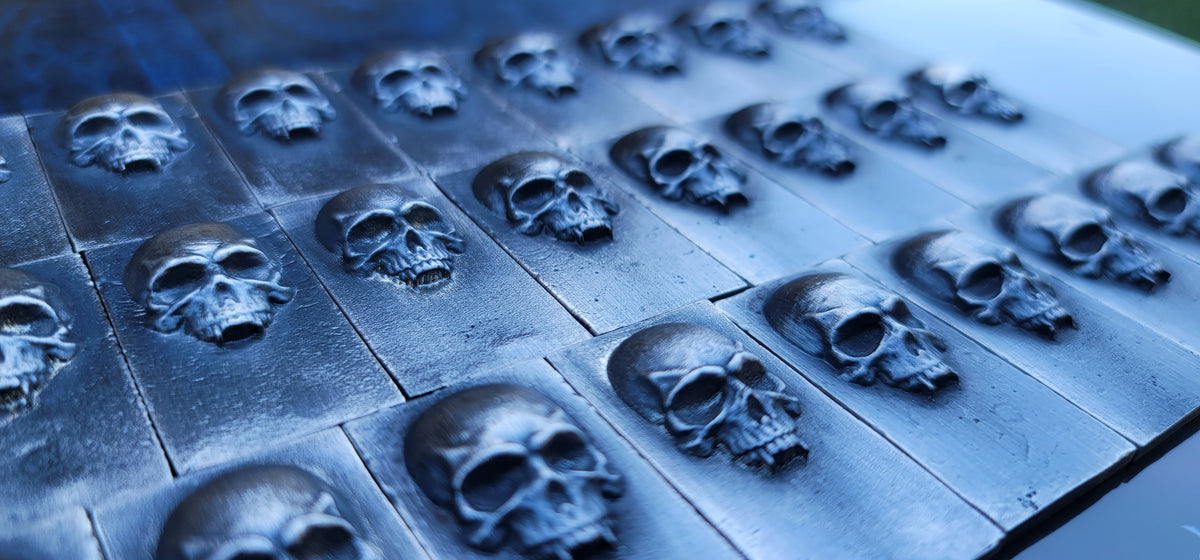 Group of 2025 Kannibal Skull Bars in .999 fine silver, arranged in rows with sculpted skull relief