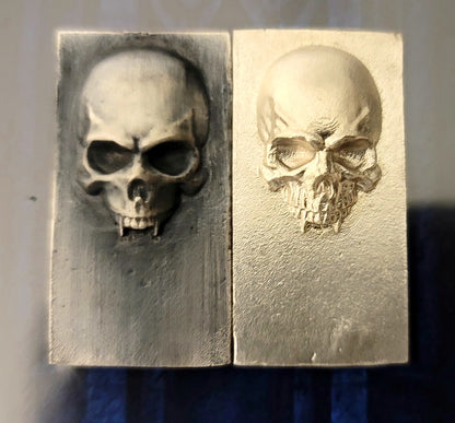 2025 Kannibal Skull Bars in antique and matte finishes, 1 oz .999 fine silver, front views side by side