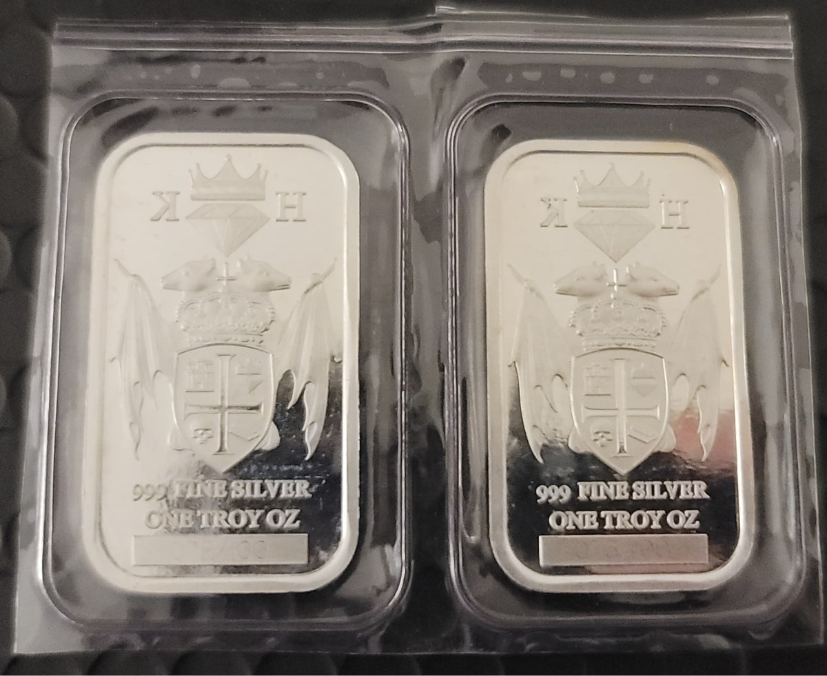 Two 2020 Kannibal Coat of Arms Transitional Reverse Bars in 1 oz .999 fine silver, shown side by side in protective sleeves