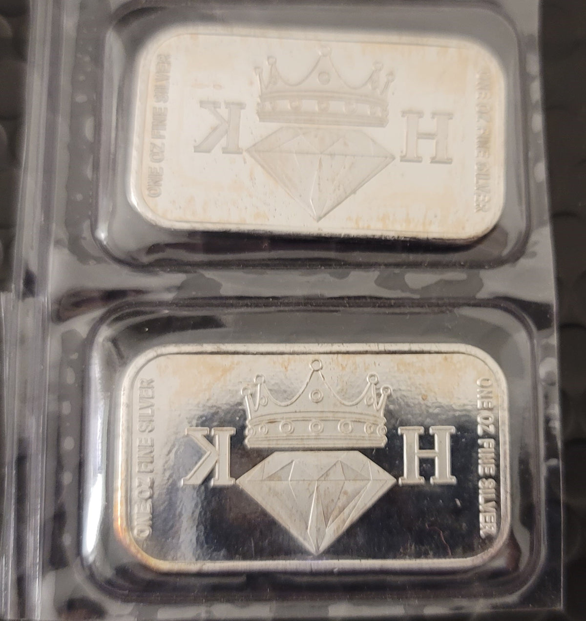 Close-up of two 2020 Kannibal Coat of Arms Transitional Reverse Bars showing the crowned diamond KH maker’s mark in .999 fine silver