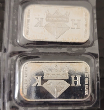 Close-up of two 2020 Kannibal Coat of Arms Transitional Reverse Bars showing the crowned diamond KH maker’s mark in .999 fine silver