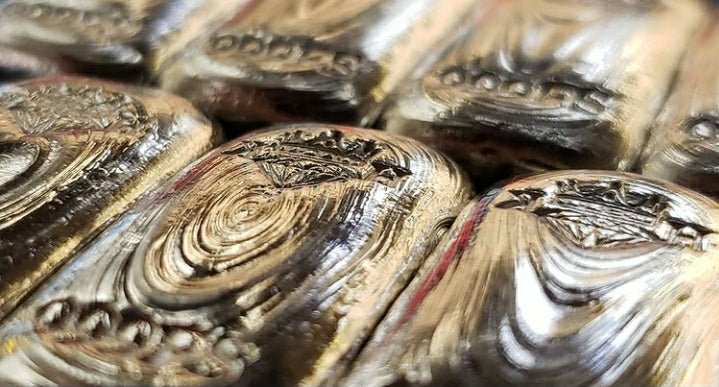 Close-up of Kannibal Hektor hand-poured .999 fine silver bars with natural pour lines and stamped purity marks
