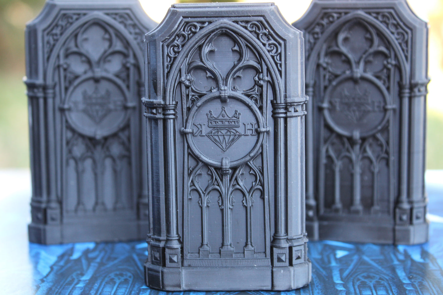 Three Gothic Sepulcher Cases for The Reliquary, featuring Cathedral-style tracery and the Kannibal Hektor crest