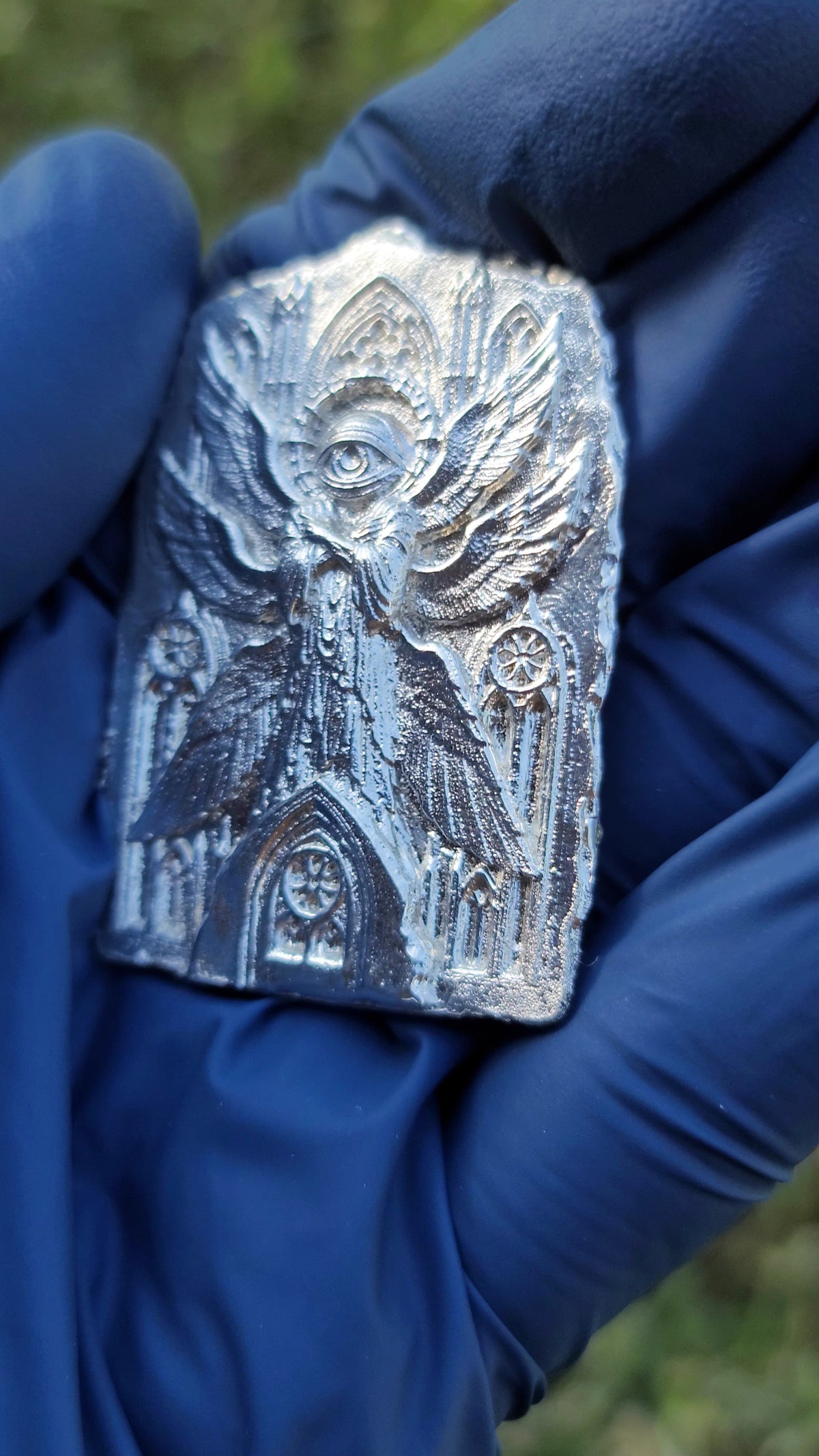Side view showing the shallow relief of The Eternal Vigil silver work.