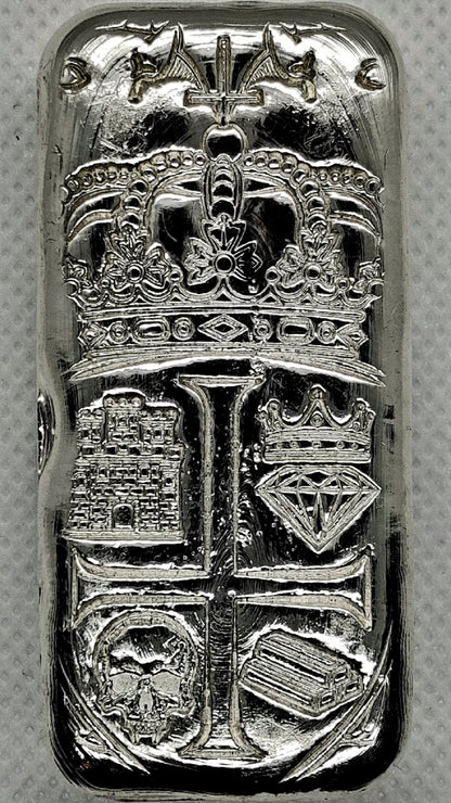 Front of Partial Coat of Arms Crest Bar in .999 fine silver, showing crown, castle, crowned diamond, skull, and bullion bar heraldic design