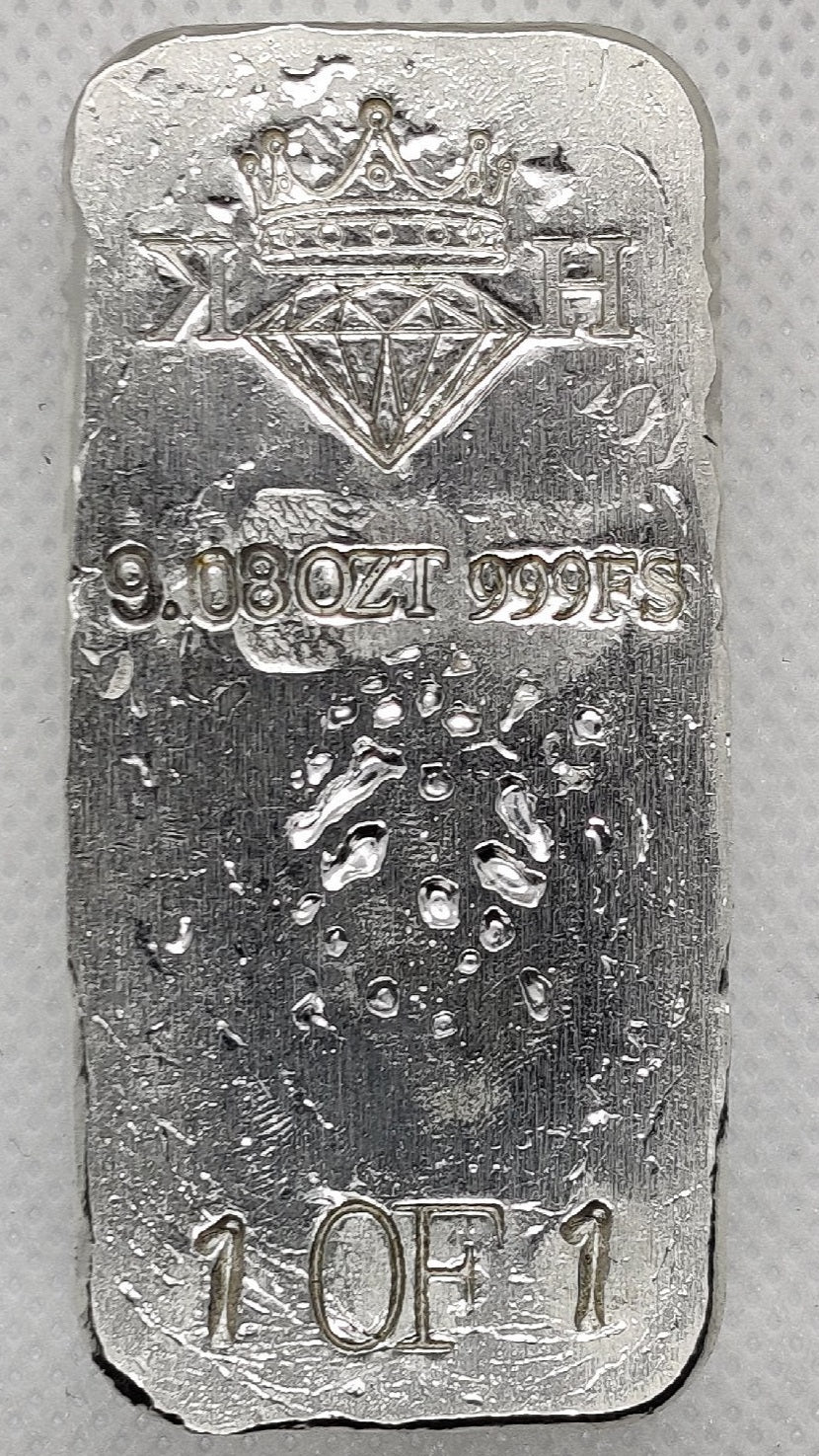 Reverse of Partial Coat of Arms Crest Bar showing crowned diamond KH maker’s mark, 9.08 oz .999 fine silver stamp, and 1 of 1 marking