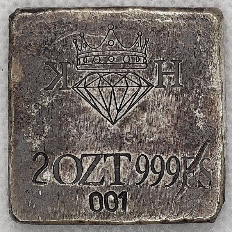 Reverse of Kannibal Hektor Coat of Arms Crest in .999 fine silver, showing KH maker’s mark, 2 oz weight, purity, and serial number