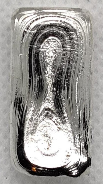 Reverse of Kannibal Hektor Basic Bar, hand-poured 1 oz .999 fine silver showing natural pour lines and cast surface