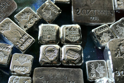 Kannibal Crest Pieces Fractional Set V.1 displayed among other hand-cast .999 fine silver bars, showing castle, crowned diamond, skull, and bullion designs
