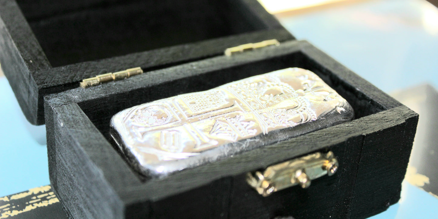 Partial Coat of Arms Crest Bar in .999 fine silver seated in custom black presentation box, shown from an angled view